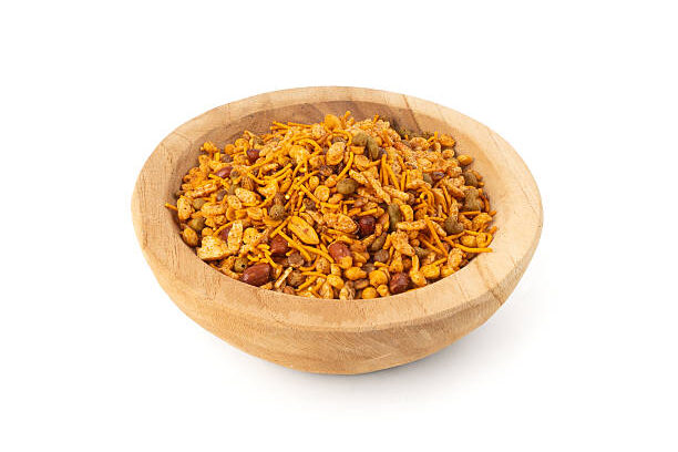 Navrattan namkeen mixture isolated. Indian nimko snack, spicy and sweet farsaan street food with baked nuts and grains, navrattan namkeen on white background